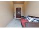 Inviting entryway with a welcome sign, comfortable bench, and a wreath on the dark wood door at 11916 Castine St, New Port Richey, FL 34654