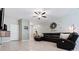 Spacious living room features tile floors, a leather sectional sofa, and elegant farmhouse-style decor at 11916 Castine St, New Port Richey, FL 34654