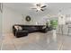 Open-concept living room boasts an oversized leather sectional sofa and seamless transition to the outdoor patio at 11916 Castine St, New Port Richey, FL 34654
