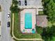 Aerial view of the community pool, surrounded by lush landscaping and lounge chairs at 11916 Castine St, New Port Richey, FL 34654