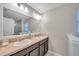 Modern bathroom with double sinks, a large mirror, and ample counter space at 12025 Greengate Dr, Hudson, FL 34669