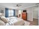 Comfortable bedroom with hardwood floors, natural light, a ceiling fan, and modern decor at 12025 Greengate Dr, Hudson, FL 34669
