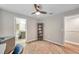 This bedroom features an ensuite bathroom, ceiling fan and light at 12025 Greengate Dr, Hudson, FL 34669