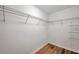 Spacious walk-in closet featuring custom shelving and hardwood floors at 12025 Greengate Dr, Hudson, FL 34669
