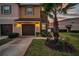 Charming two-story home with a well-maintained lawn and attached two-car garage at 12025 Greengate Dr, Hudson, FL 34669