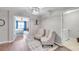 Hallway leading to a bedroom and laundry room with two armchairs and decor at 12025 Greengate Dr, Hudson, FL 34669
