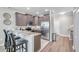 Kitchen with mocha cabinetry, stainless steel appliances, and a breakfast bar overlooking the living area at 12025 Greengate Dr, Hudson, FL 34669