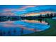 Scenic lake view reflects the colorful sunset, enhancing this beautiful property at 12025 Greengate Dr, Hudson, FL 34669