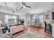 Spacious living area featuring hardwood floors, neutral walls, ceiling fans, and dining area at 12025 Greengate Dr, Hudson, FL 34669