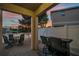 Covered patio with outdoor dining and serene lake view at 12025 Greengate Dr, Hudson, FL 34669