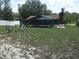 Large backyard with screened pool and seating area, perfect for outdoor relaxation and entertaining at 12411 Brookside St, Spring Hill, FL 34609