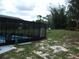 The fenced-in backyard features a screened-in pool area, providing privacy and a space for outdoor activities at 12411 Brookside St, Spring Hill, FL 34609