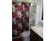 Cozy bathroom with floral shower curtain and white storage cabinet at 12411 Brookside St, Spring Hill, FL 34609