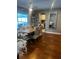 Spacious dining room featuring a large table, hardwood floors, and decorative shelving at 12411 Brookside St, Spring Hill, FL 34609