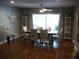 Elegant dining room featuring stylish chairs, a large window, and modern decor at 12411 Brookside St, Spring Hill, FL 34609