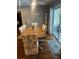 Bright dining room with hardwood floors, a large dining table, and sliding glass doors at 12411 Brookside St, Spring Hill, FL 34609