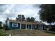 Charming single-story home with blue siding, white trim, and a well-maintained front yard at 12411 Brookside St, Spring Hill, FL 34609