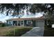 Charming single-story home with blue siding, white trim, and an attached two-car garage at 12411 Brookside St, Spring Hill, FL 34609