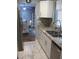 Modern kitchen featuring granite countertops, stainless steel appliances, and a view of the dining room at 12411 Brookside St, Spring Hill, FL 34609