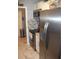 Efficient kitchen with stainless steel appliances, white cabinets, and updated backsplash at 12411 Brookside St, Spring Hill, FL 34609