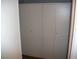 White wardrobe cabinets with doors and handles at 12411 Brookside St, Spring Hill, FL 34609