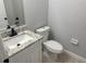 Bathroom featuring a white vanity with granite countertop, modern faucet, and convenient toilet and paper holder at 1309 29Th S St, St Petersburg, FL 33712