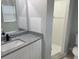 Bathroom features granite counters, updated vanity, a walk-in shower, and modern fixtures at 1309 29Th S St, St Petersburg, FL 33712