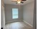 This quaint bedroom offers a tile floor, closet, modern ceiling fan, and natural light from its window at 1309 29Th S St, St Petersburg, FL 33712