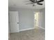 Neutral bedroom featuring tile flooring, gray walls, and doors leading to an additional room at 1309 29Th S St, St Petersburg, FL 33712