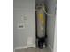 Functional laundry area with water heater, hookups, and shelving, providing a practical space at 1309 29Th S St, St Petersburg, FL 33712