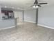 Open living room featuring tile floors, a ceiling fan, and access to the kitchen with stainless steel appliances at 1309 29Th S St, St Petersburg, FL 33712