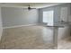 Open living area with tile floors and gray walls adjacent to kitchen and breakfast bar, promoting seamless living at 1309 29Th S St, St Petersburg, FL 33712
