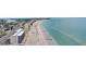 This aerial shows an impressive building conveniently located next to a sandy beach and blue ocean at 14300 Gulf Blvd # 104, Madeira Beach, FL 33708