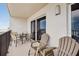 Balcony with a table, chairs, and ocean views at 14300 Gulf Blvd # 104, Madeira Beach, FL 33708