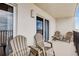 Relax on this balcony with chairs, offering a glimpse of the sky and ocean at 14300 Gulf Blvd # 104, Madeira Beach, FL 33708