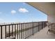 Enjoy beach views from this balcony with black metal railing and seating at 14300 Gulf Blvd # 104, Madeira Beach, FL 33708