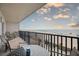 Relax on the balcony with a table and chairs overlooking the beach with ocean views at 14300 Gulf Blvd # 104, Madeira Beach, FL 33708