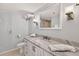 Bright bathroom with marble countertop, white cabinetry, and modern fixtures at 14300 Gulf Blvd # 104, Madeira Beach, FL 33708