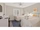 Bright bedroom with twin beds, ceiling fan, and beach-themed decor at 14300 Gulf Blvd # 104, Madeira Beach, FL 33708