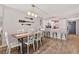 Dining area with modern lighting and seating plus a view to the kitchen bar at 14300 Gulf Blvd # 104, Madeira Beach, FL 33708