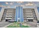 View of the building's exterior, featuring private balconies and covered parking at 14300 Gulf Blvd # 104, Madeira Beach, FL 33708