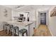 Modern kitchen with white cabinets, stainless steel appliances, and countertop seating at 14300 Gulf Blvd # 104, Madeira Beach, FL 33708