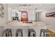 Bright kitchen featuring white cabinets, stainless steel appliances, and a spacious marble countertop at 14300 Gulf Blvd # 104, Madeira Beach, FL 33708