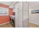 Efficient laundry area with washer, dryer, and ample cabinet space at 14300 Gulf Blvd # 104, Madeira Beach, FL 33708