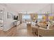 Inviting living room featuring a mirrored wall and expansive ocean views from the balcony at 14300 Gulf Blvd # 104, Madeira Beach, FL 33708