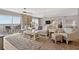 Bright living room with comfortable seating and beach view balcony access at 14300 Gulf Blvd # 104, Madeira Beach, FL 33708