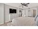 Main bedroom with ensuite bath featuring a ceiling fan and spacious closet at 14300 Gulf Blvd # 104, Madeira Beach, FL 33708