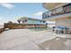 Outdoor pool and patio area perfect for relaxing, complemented by the convenience of nearby building access at 14300 Gulf Blvd # 104, Madeira Beach, FL 33708