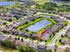 Bird's eye view of a home located near a pond with a backdrop of a lush green landscape at 1601 Fox Grape Loop, Lutz, FL 33558