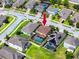 Aerial view of a single Gathering home in a suburban neighborhood with a private pool and red arrow marker at 1601 Fox Grape Loop, Lutz, FL 33558